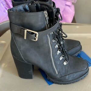 Ladies combat style boots with silver/grey accessories.